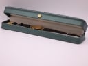 The Tissot Stylist watch displayed in a green presentation box, a studio prop.