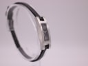 Angled side view of the Gucci 3900L watch on a clear stand.