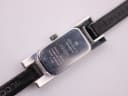 Close-up of the Gucci 3900L stainless steel case back showing model, serial, and water resistance engravings.
