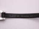 Close-up of the underside of the black leather strap, showing "GUCCI ® GENUINE LEATHER" embossed text.
