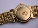 Close-up of the watch case back, showing the '3400 L' model number and engraved Gucci crest, with some surface wear.