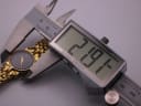 Digital caliper measuring the case diameter of the Gucci watch, displaying a precise measurement of 21.9mm.