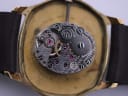 Macro view of the Tissot manual wind movement, showing gears and jewels.