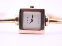 Close-up, face-on view of the Gucci 1900L watch dial, clearly showing 'GUCCI' at 12 o'clock and 'SWISS MADE' at 6 o'clock, with gold-coloured hands.