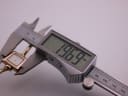 Digital caliper measuring the case diameter of the Gucci 1900L, displaying a precise measurement of 19.69mm.