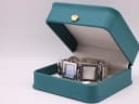 The D&G Time watch resting in a green studio presentation box.