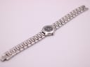 Full length overhead view of the Tissot G331K watch and its integrated silver-tone bracelet.