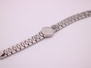 Angled back view of the Tissot watch, showing the case back and the full bracelet length.