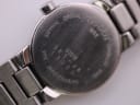 Close-up of the Tissot watch case back with engravings for 'Sapphire Crystal', '30M Water Resistant', 'Stainless Steel', 'G331K', and serial number details.