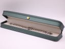 The Tissot watch displayed neatly inside a generic green presentation box (studio prop).