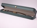 The Tissot watch displayed inside a green leatherette presentation box with a gold crown emblem.