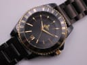 Close-up front view of the black textured dial with gold-tone baton indices, Roman numeral VI, and Vivienne Westwood orb logo.