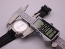 Digital caliper measuring the watch case, displaying a precise diameter of 38.07mm.