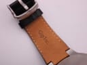 Close-up of the inner lining of the black leather strap, showing the 'Gap Inc.' stamp.