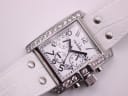 Overhead close-up of the dial, white alligator-pattern leather strap, and case details.