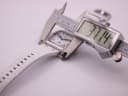 Digital caliper measuring the case diameter of the rectangular watch as 37.14mm.