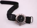 Top-down view of the Police watch with its black fabric strap fully extended against a white background.
