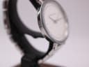 Alternative angled side view of the Michael Kors watch, highlighting the smooth curve of the case.