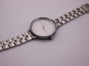 Overhead view of the Michael Kors watch laid flat, displaying the full length of the silver-tone stainless steel bracelet.