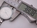 Digital caliper measuring the case diameter of the Michael Kors watch at 38.08mm.