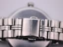Close-up view of the signed 'MICHAEL KORS' fold-over clasp on the stainless steel bracelet.