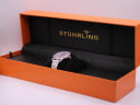 Stührling Original watch nestled on a cushion inside its orange original presentation box with gold branding.