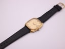 Overhead view of the Certina Newport watch with black leather strap laid flat on a white background.