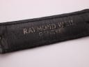 Close-up of the underside of the black leather strap showing 'RAYMOND WEIL GENEVE' stamping.