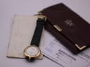 Raymond Weil 5350 watch displayed alongside its original brown document holder and papers.