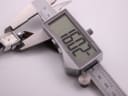 Digital caliper measuring the width of the Helvetia watch case, with the display showing an exact measurement of 16.22mm.