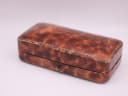 Closed view of the vintage brown presentation box with a textured faux leather finish.