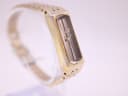 Side profile view of the gold tone rectangular Seiko watch, showing light wear on the plating.