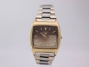 Front view of vintage Seiko 6379-5020 automatic watch with gold-plated tonneau case, brown gradient dial, and two-tone steel bracelet.