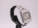 Opposite angled side view of vintage Seiko 6119-5401 showing case lines and integrated bracelet, on stand.