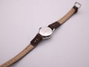 Rear view of the Seiko watch, showing the case back with serial number and strap laid out.