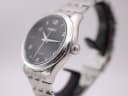 Angled side view showing the polished stainless steel case and crown of the Seiko V157-0CNO.