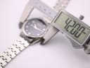 Digital caliper measuring the case diameter of the watch, displaying 42.00mm.