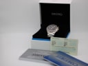 Front view of the Seiko 7T92-0FX0 chronograph in its original Seiko box, with accompanying papers.