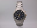 Front view of the Seiko 7T92-0FX0 chronograph with its blue dial, gold accents, and stainless steel bracelet.