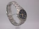 Another angled side view of the Seiko watch, showing the integrated stainless steel bracelet and case profile.