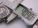 Digital caliper measuring the case diameter of the Seiko watch, showing an exact reading of 40.9mm.