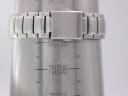 The stainless steel bracelet of the Seiko watch on a wrist sizing gauge, indicating a wrist circumference of approximately 20.3cm.
