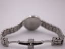 Rear view of the opened stainless steel butterfly deployant clasp with "TISSOT" engraved, and bracelet links.