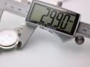 Digital caliper measuring the Tissot watch case, displaying an exact diameter of 29.90mm.