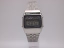 Front view of vintage Seiko A159-5009-G digital LCD watch with silver stainless steel case and bracelet, showing 4:07:01 on display.