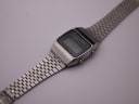 Top-down angled view of the Seiko A159-5009-G watch, displaying the rectangular case and full length of the integrated steel bracelet.