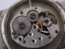 Macro shot of the Jesty watch's manual wind movement, marked 'SWISS UNADJUSTED'.