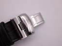 Close-up of the Tissot branded, polished stainless steel deployment clasp on the brown leather strap.