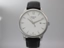 Front view of the Tissot T063610 A watch, showcasing its crisp white dial, silver-tone baton indices, and Arabic numerals at 12 and 6 o'clock.
