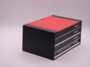 The original Tissot watch presentation box, a red and black design, shown closed.
